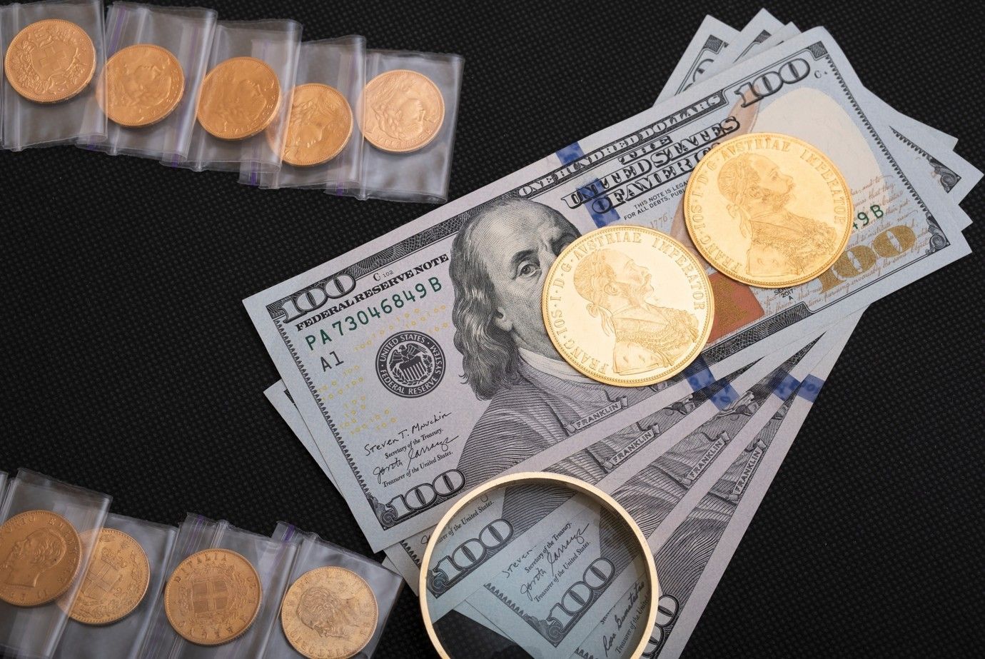 A pile of money and gold coins on a table.