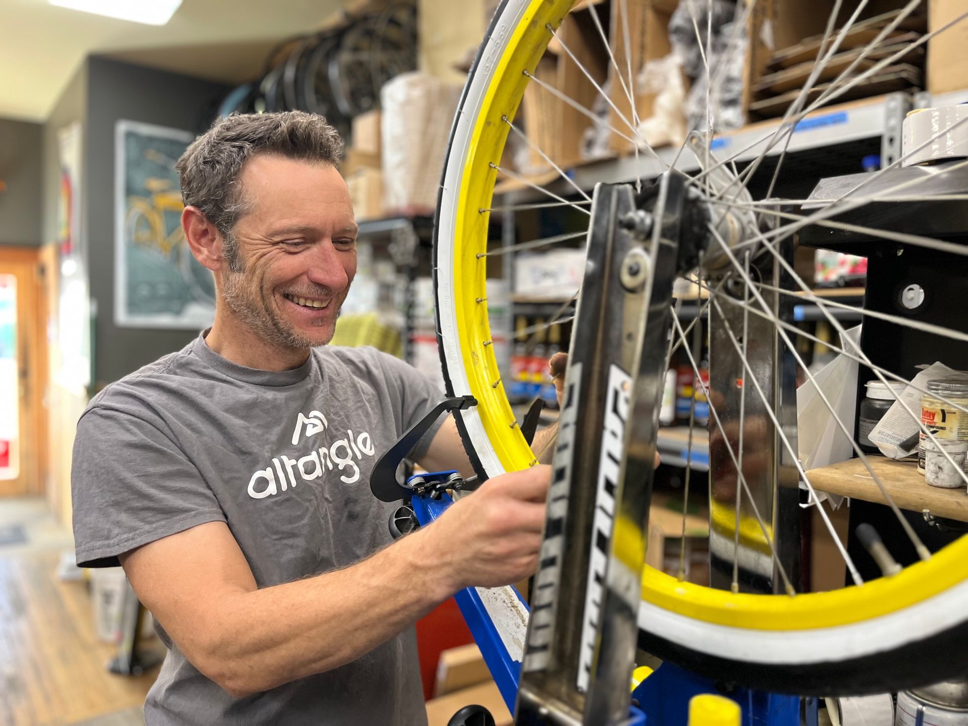 bicycle mechanics working on bikes in repair stands