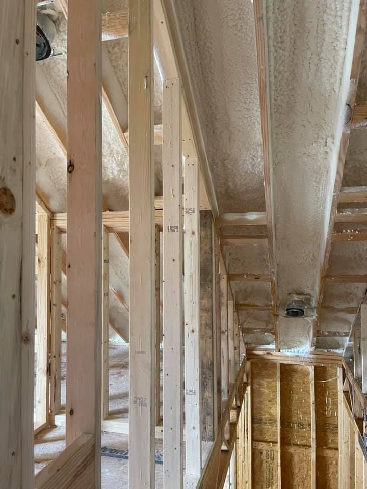 Interior view of unfinished construction; wooden framework and ductwork.