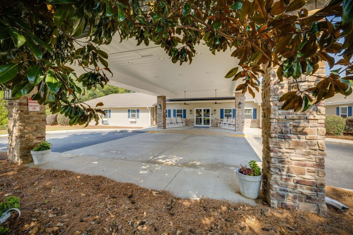A large building with a lot of trees in front of it.
