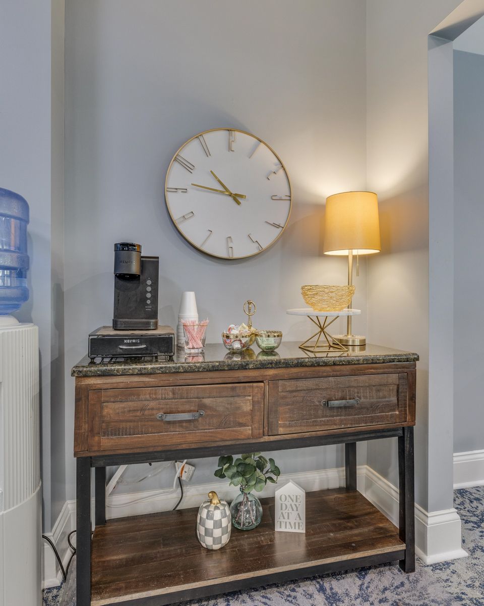 A room with a table and a clock on the wall