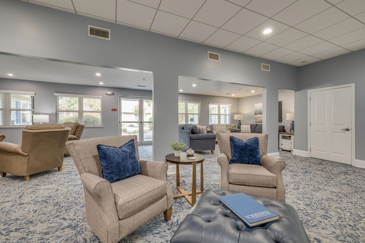 There are two chairs and an ottoman in the living room.