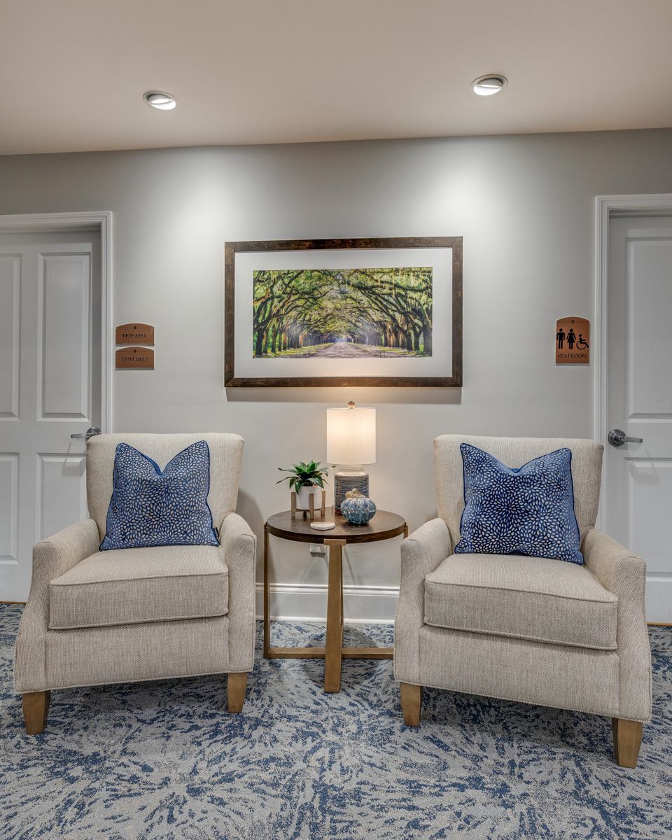 There are two chairs and a table in the room.