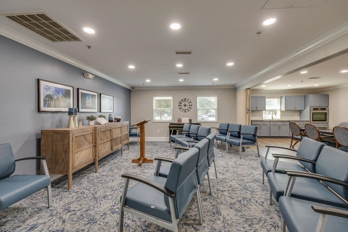 A large room with a lot of chairs and a podium.