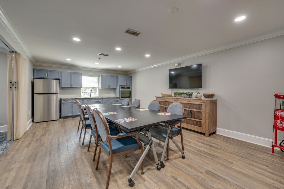 There is a large table and chairs in the middle of the room.