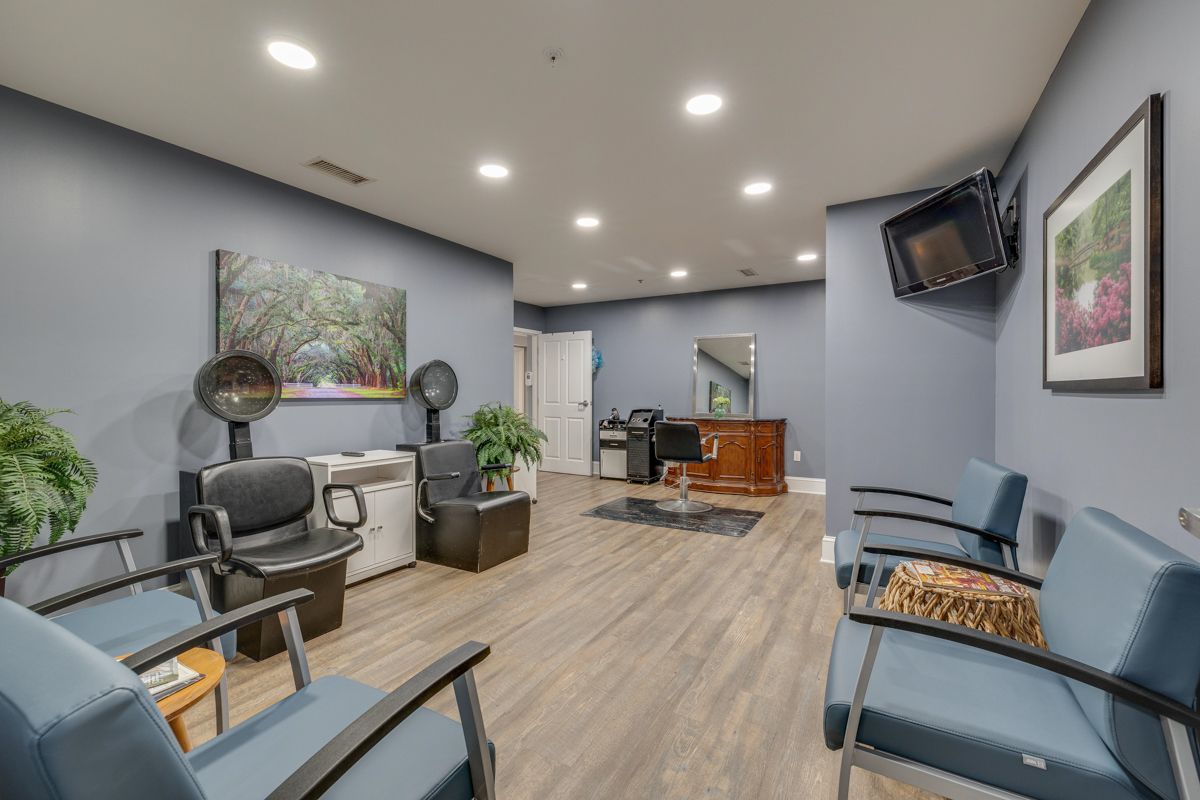 A waiting room with chairs and a television on the wall.