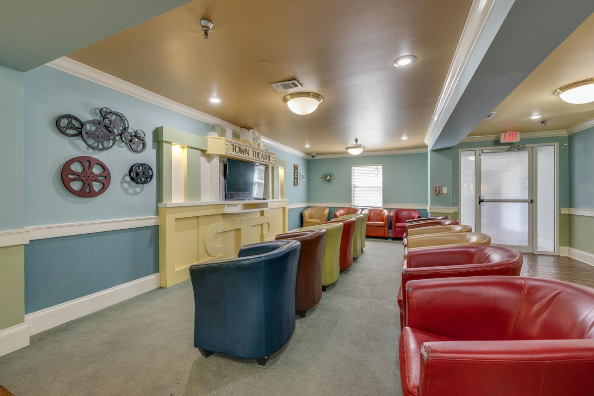 A living room with a lot of chairs and a bar.