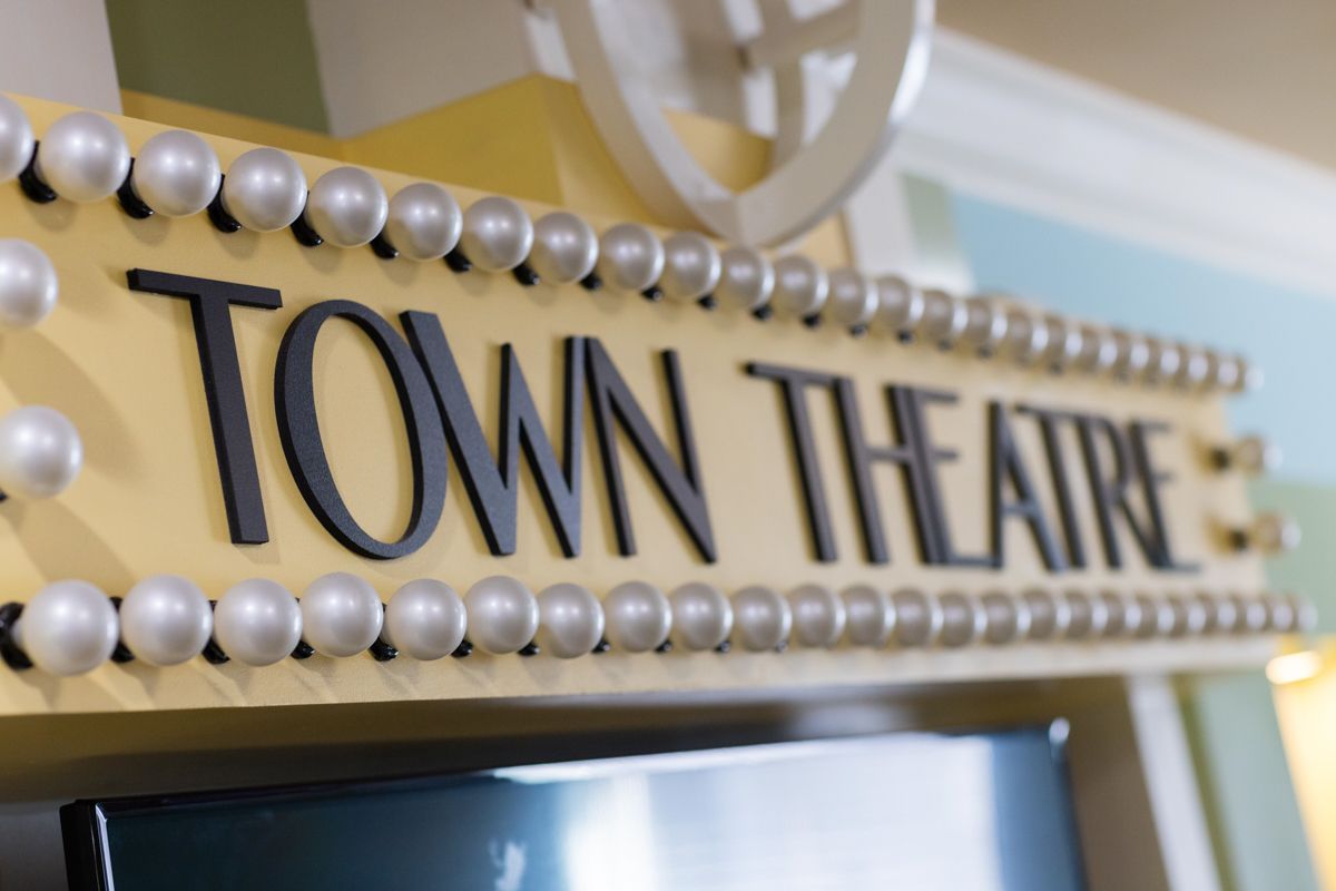 A close up of a sign for the town theatre