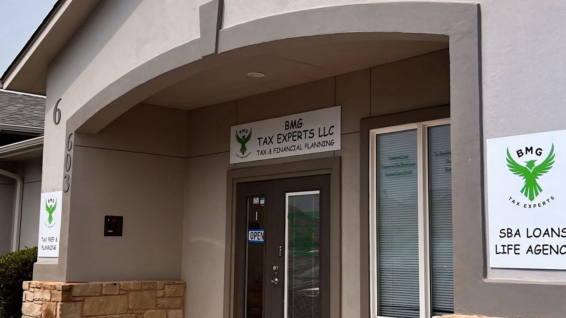 A building with a sign that says tax experts llc