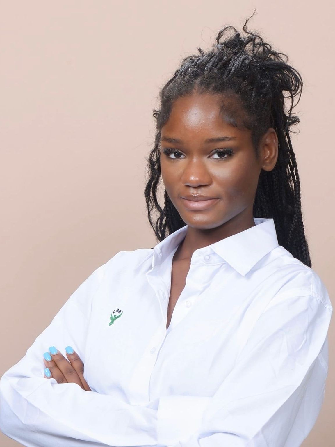 A woman in a white shirt with her arms crossed