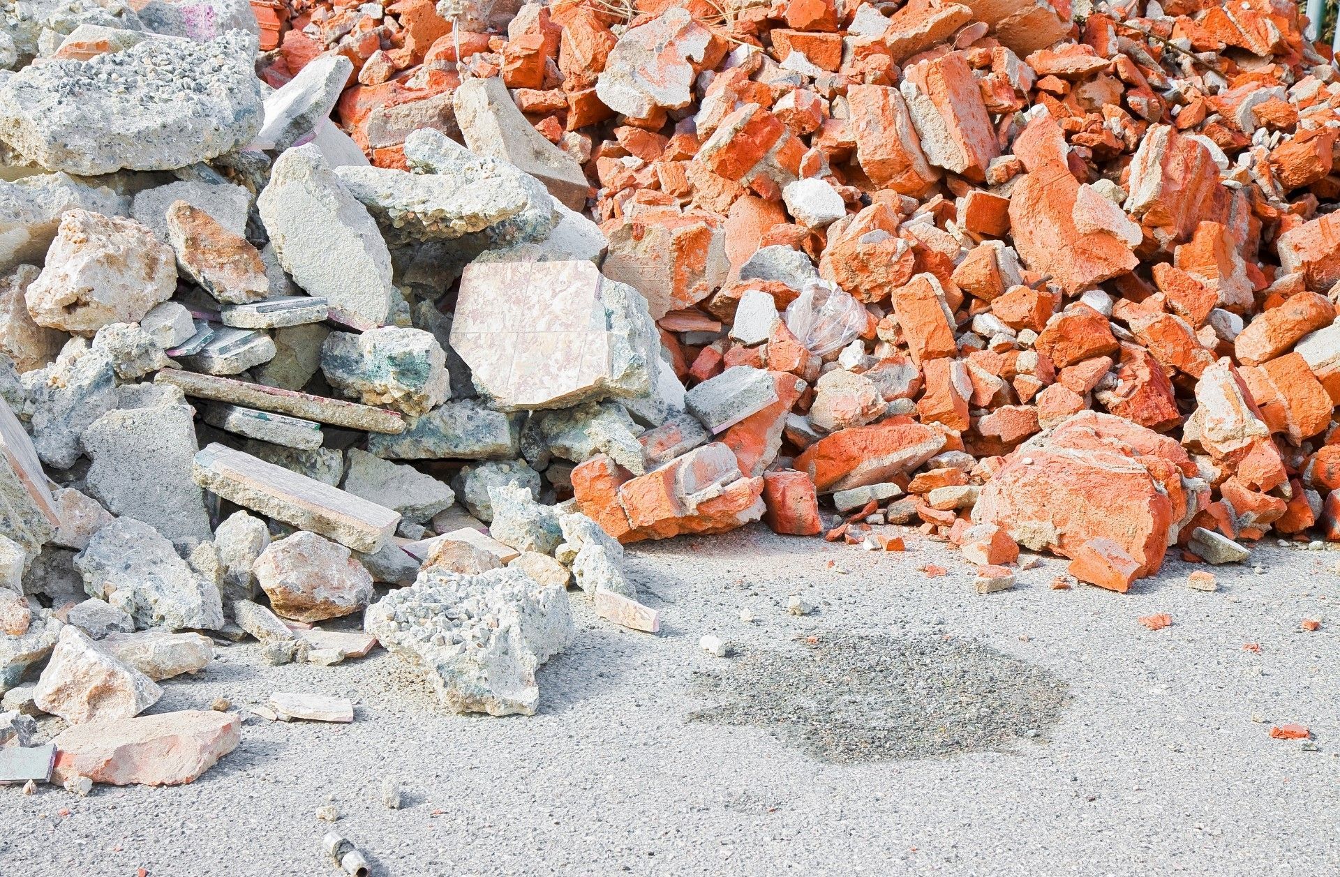 Mac's Junk Removal | A pile of rocks and bricks on the ground.