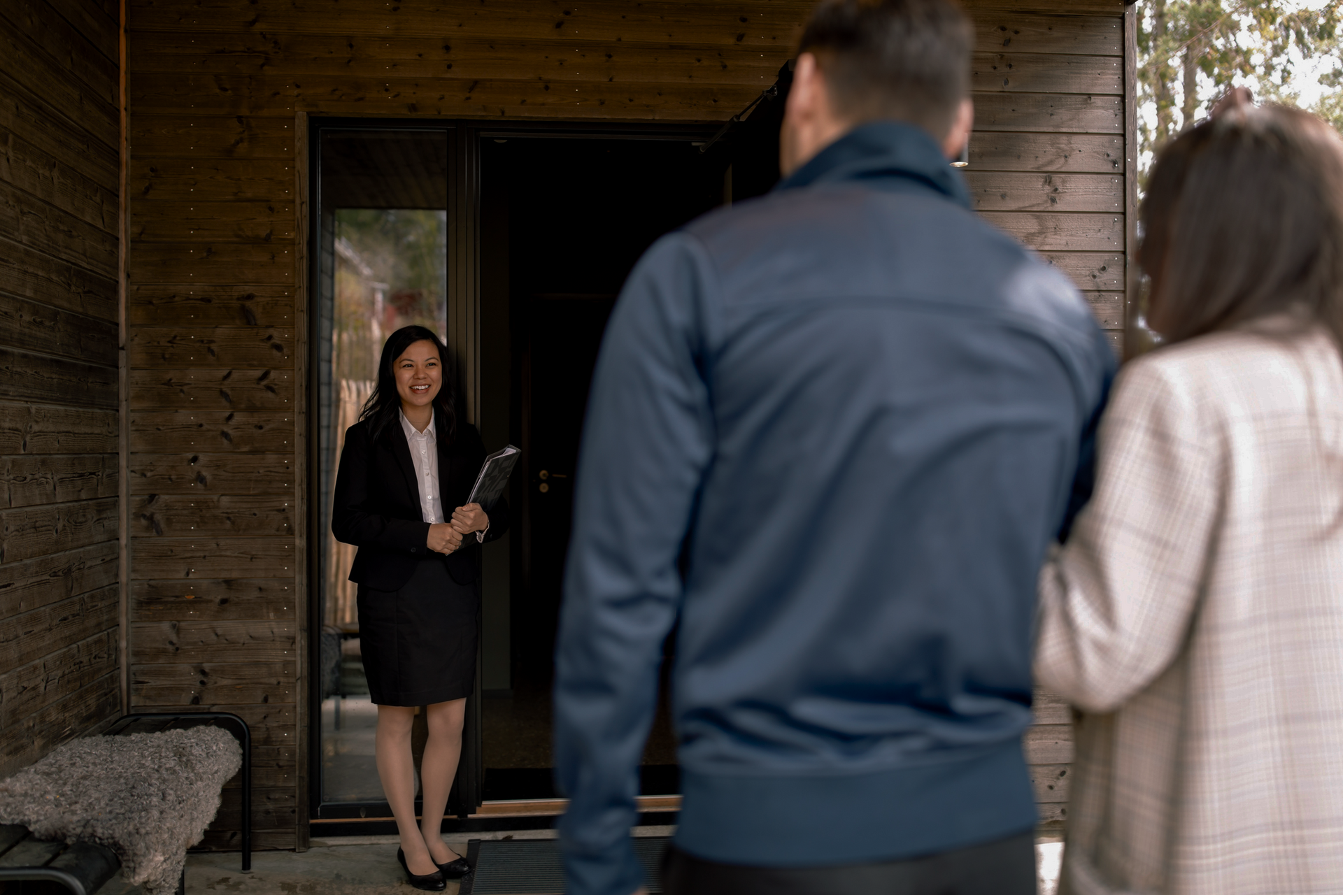 A Man and A Woman Are Standing in Front of A Wooden House | St. Augustine, FL | Superior Real Estate Services