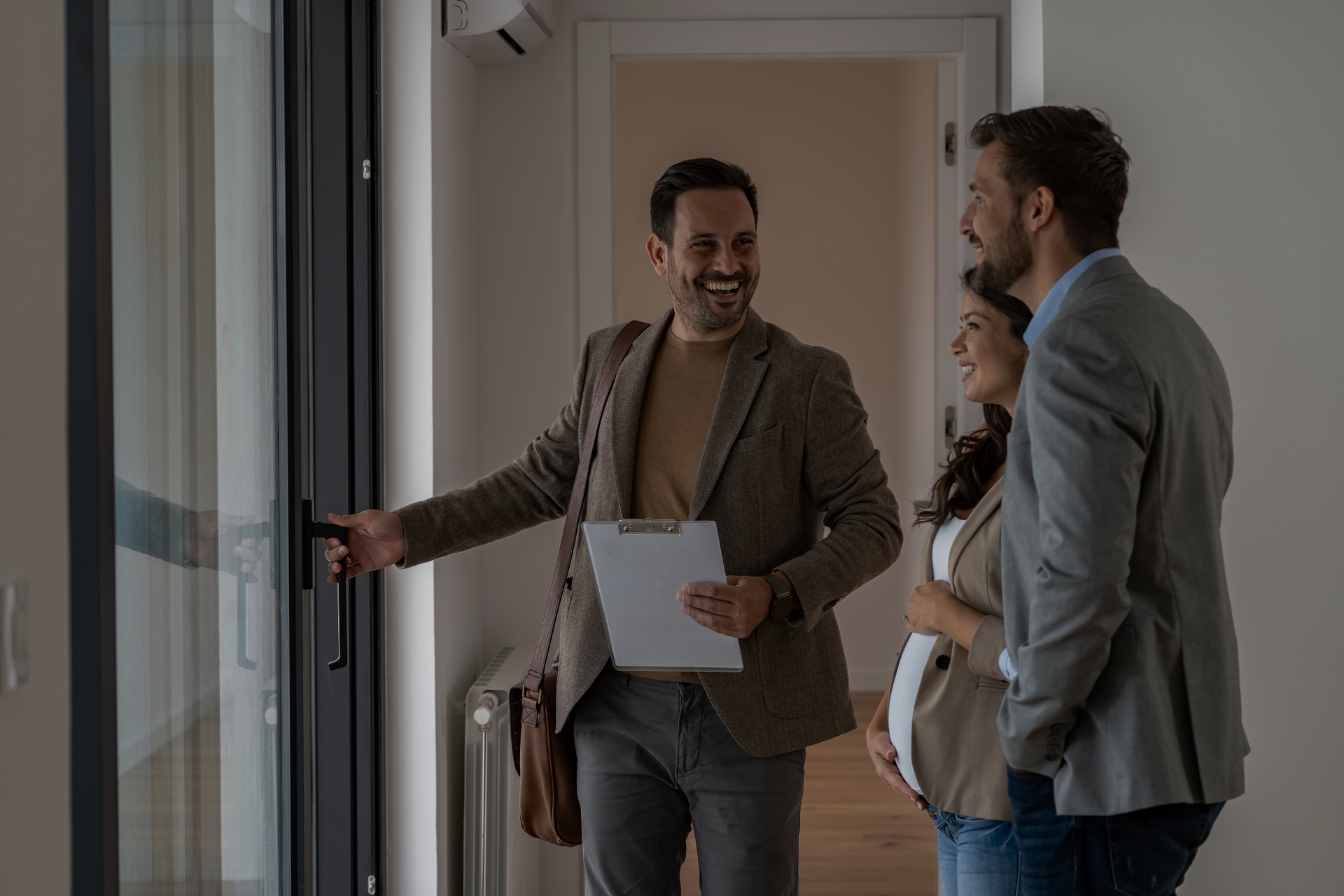 A Man Is Showing a Pregnant Woman and A Man a Room | St. Augustine, FL | Superior Real Estate Services