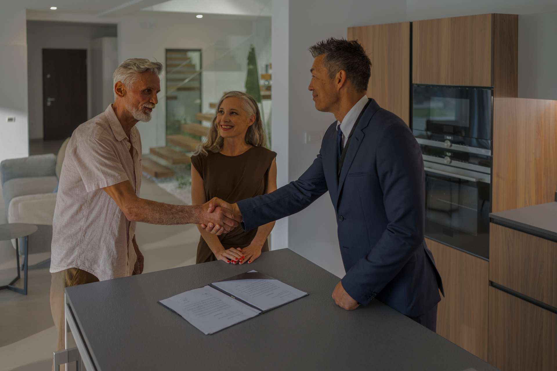 A Man and Woman Are Shaking Hands with A Real Estate Agent | St. Augustine, FL | Superior Real Estate Services