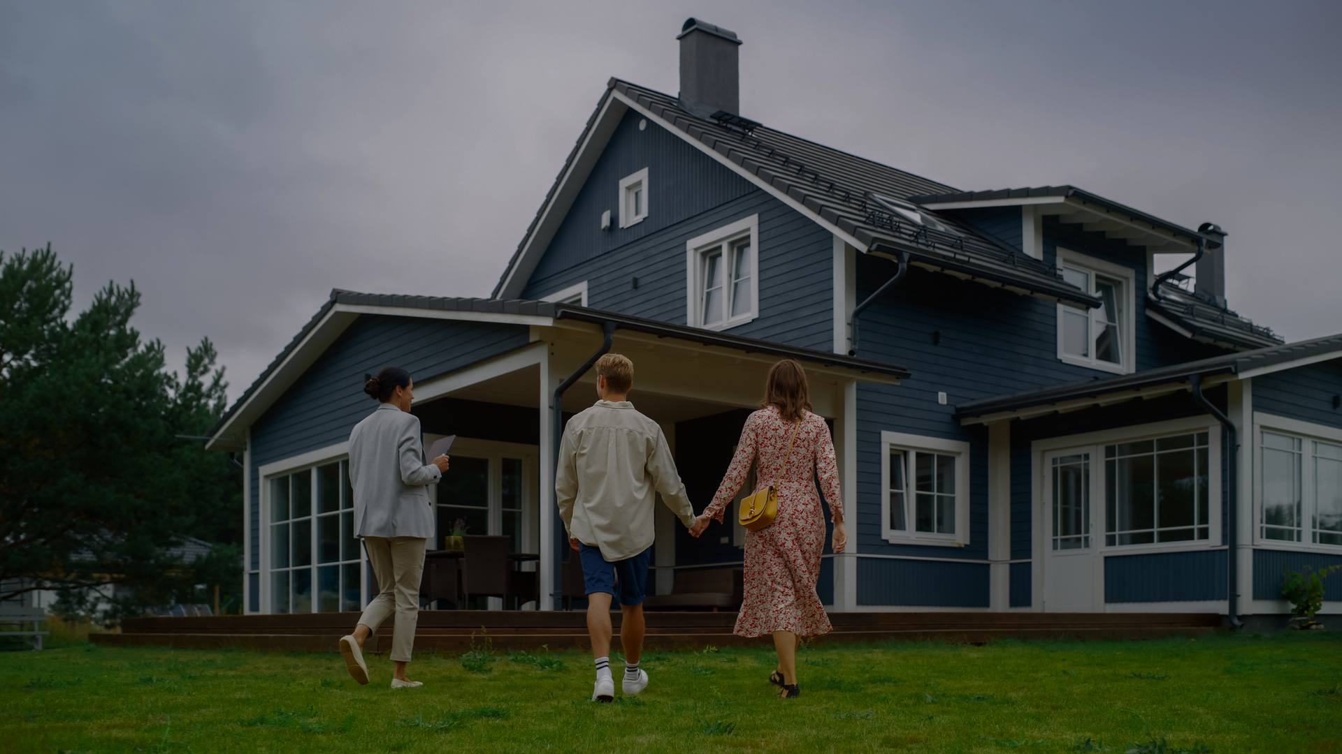 A Family Is Walking Towards a Blue House Holding Hands | St. Augustine, FL | Superior Real Estate Services
