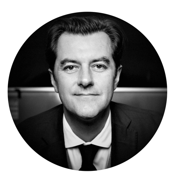 A black and white photo of a man in a suit and tie