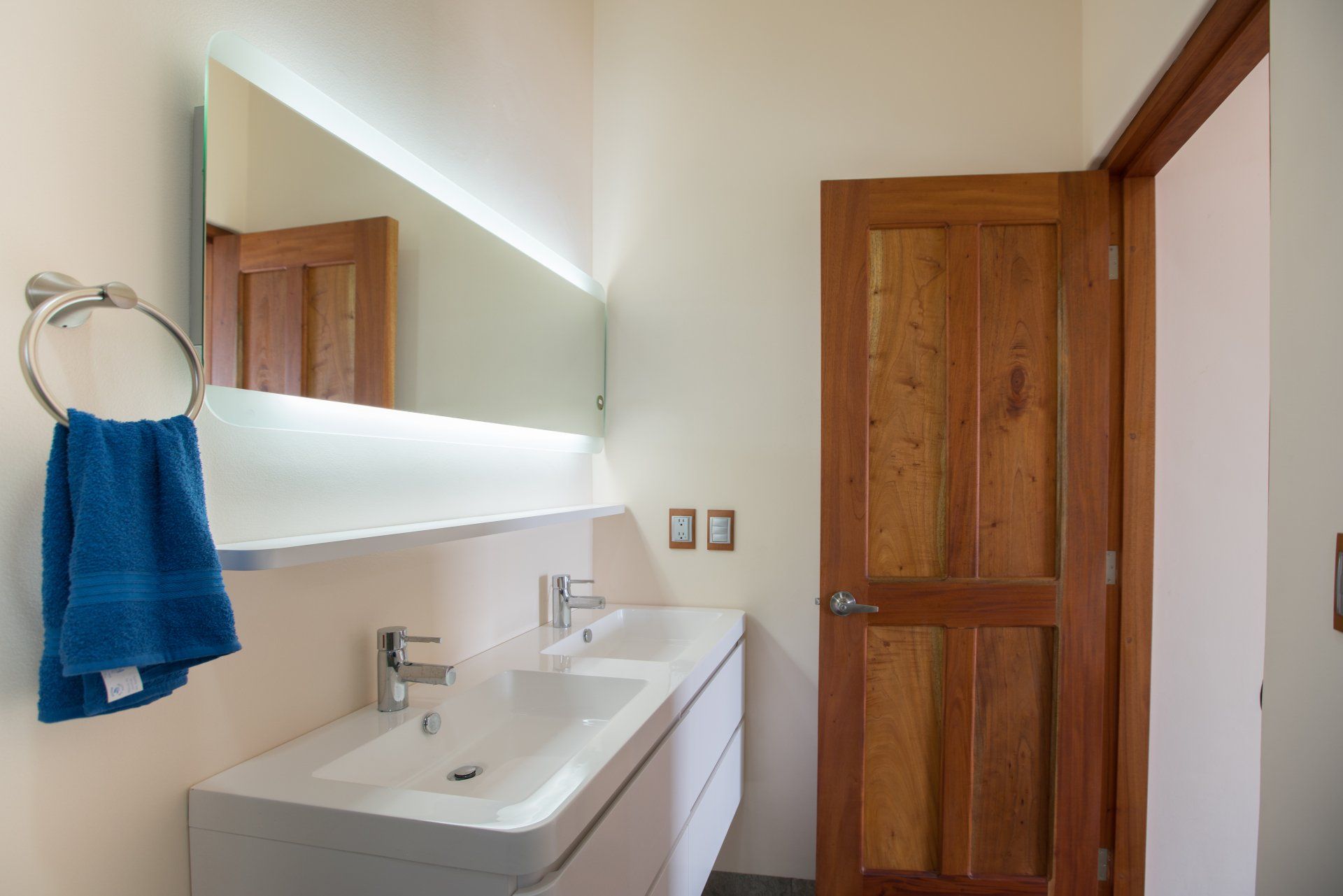 A bathroom with two sinks and a large mirror.