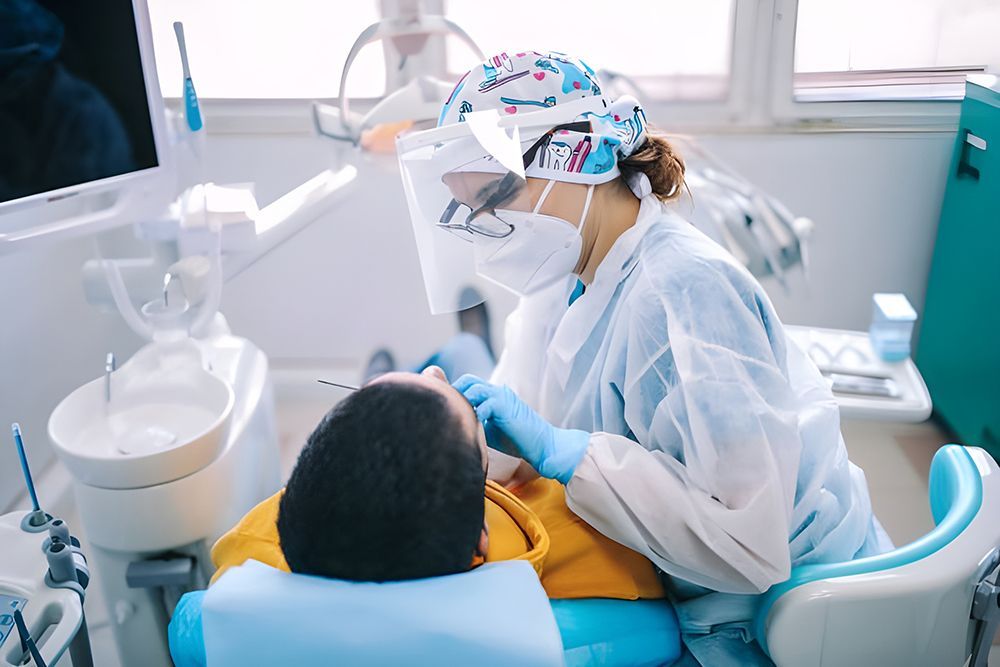 A Dentist is Examining a Patient's Teeth in a Dental Office — Dentist On Tweed in Tweed Heads, NSW