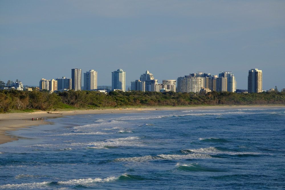 Beach With A City Skyline In The Background And A Body Of Water — Dentist On Tweed in Tweed Heads, NSW