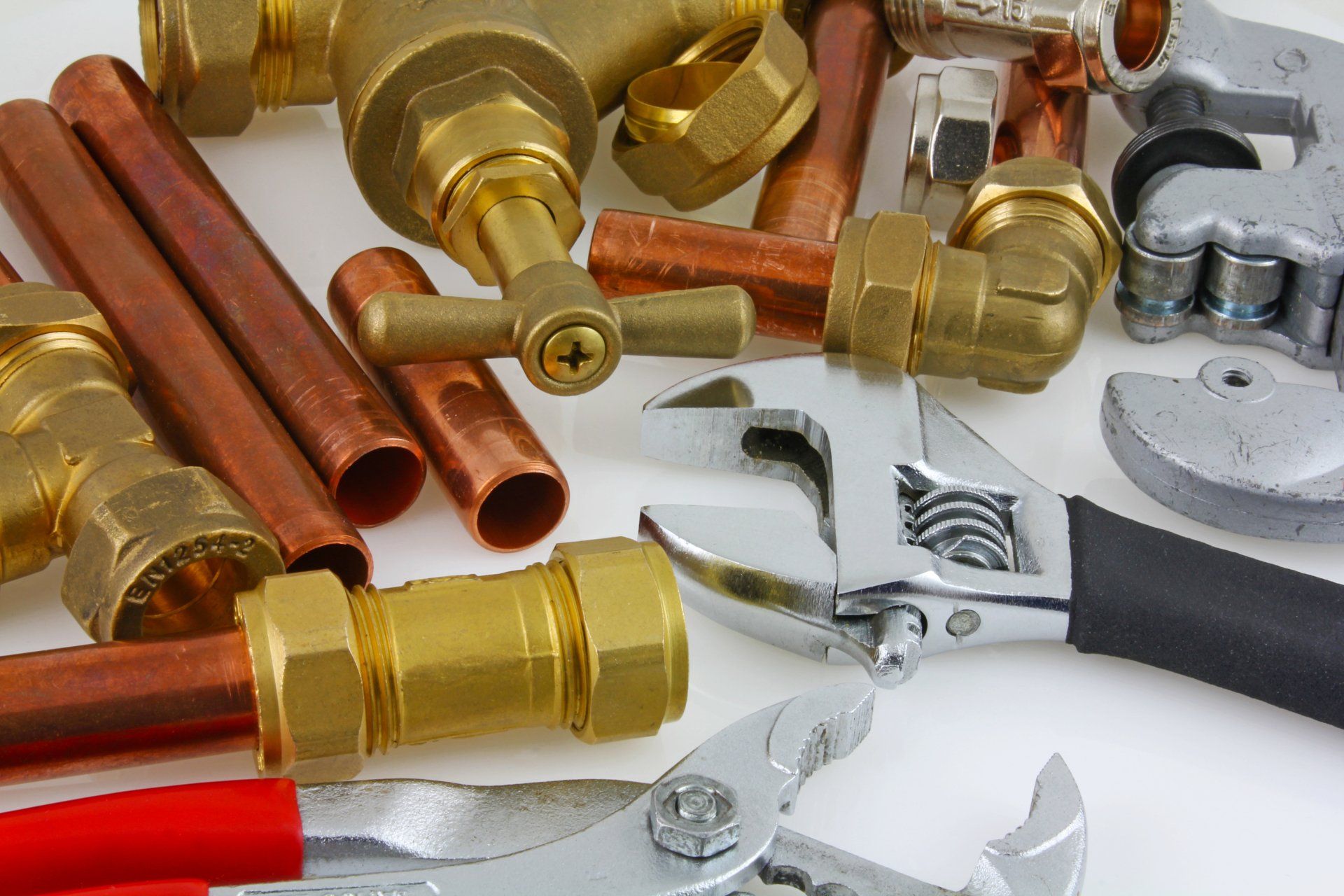 There are many different types of plumbing tools on the table.
