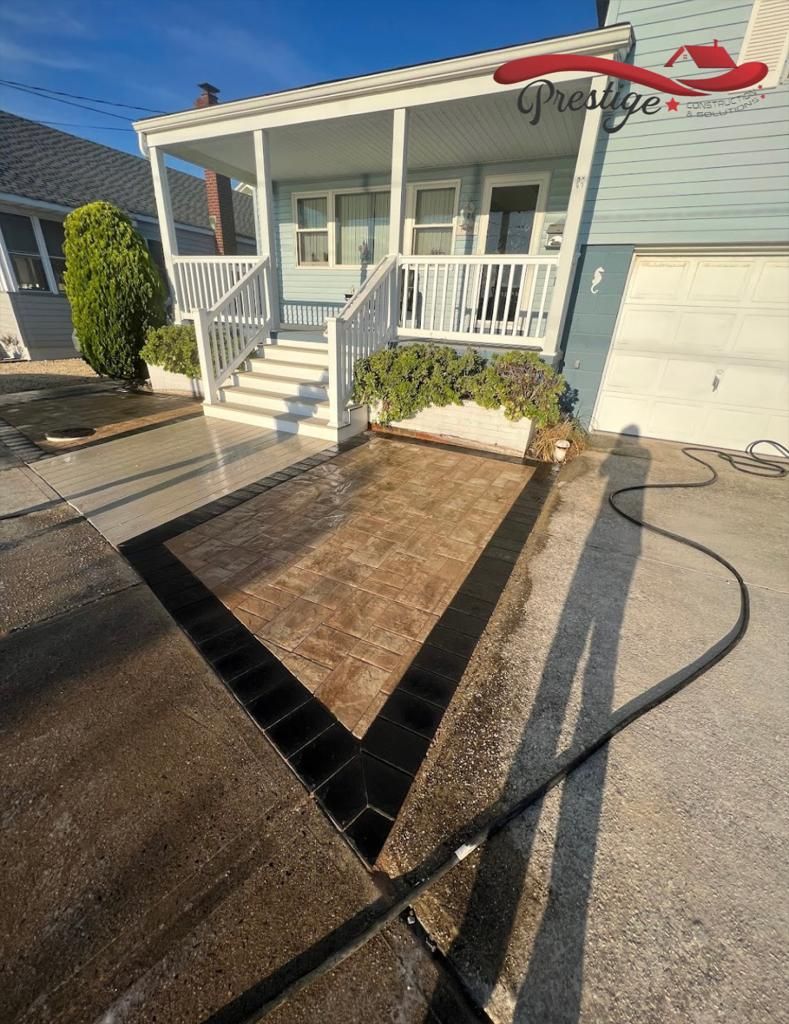 A house is being cleaned with a pressure washer.