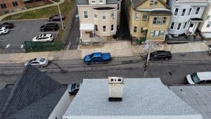 An aerial view of a house with a chimney on the roof.