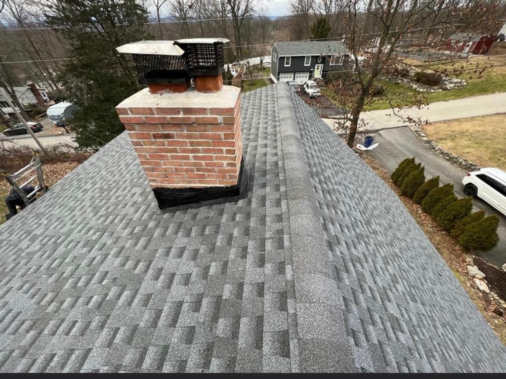 An aerial view of a roof with a chimney on top of it.