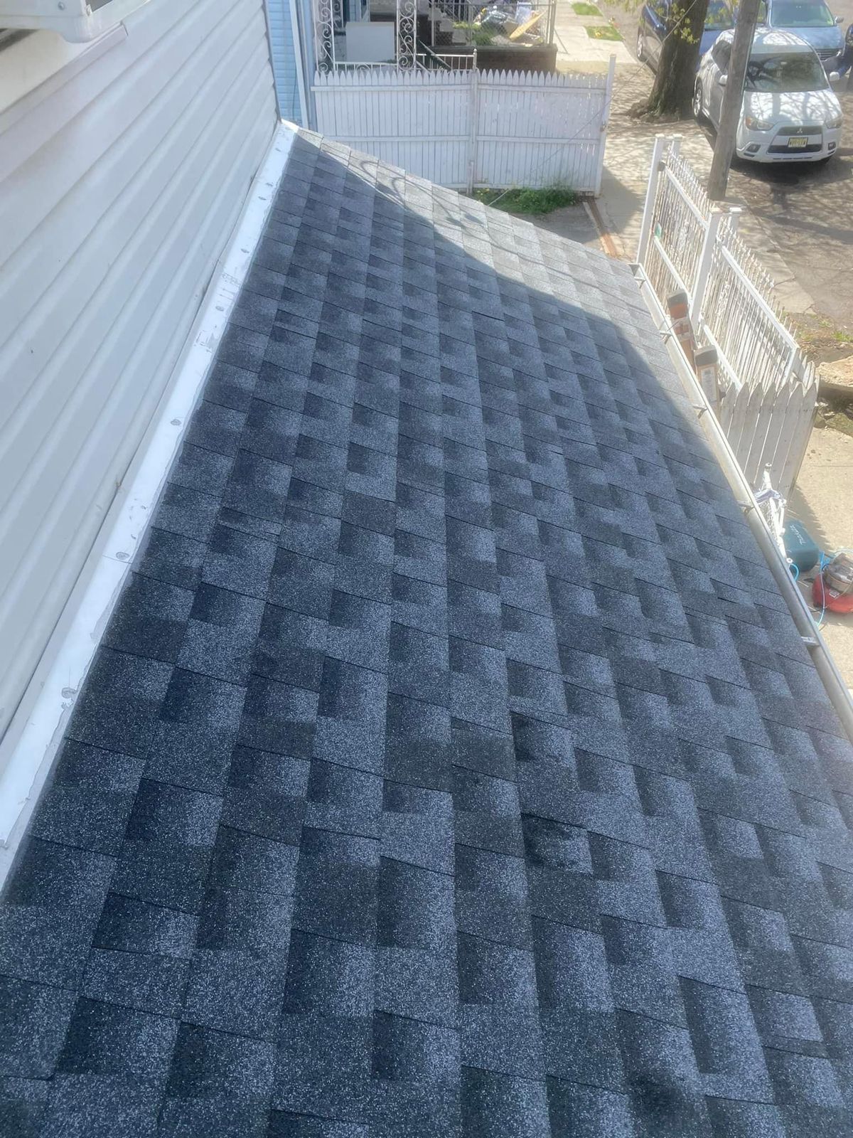 A close up of a roof with shingles on a house.