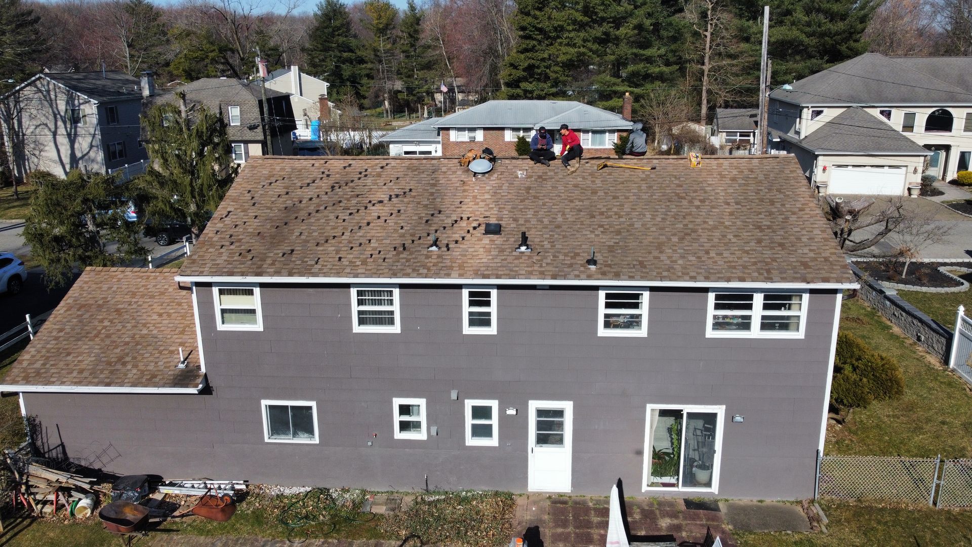 An aerial view of a house with a roof that is being repaired.