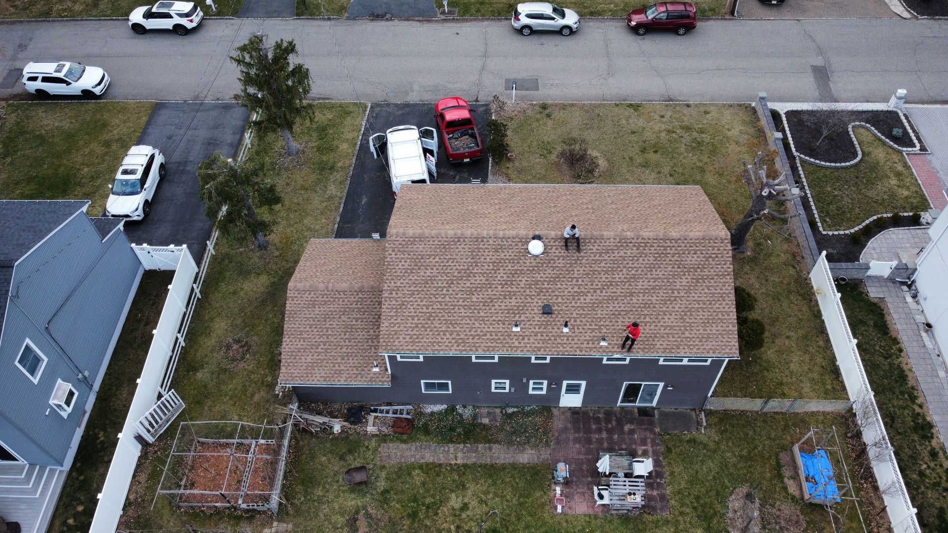 An aerial view of a house under construction in a residential neighborhood.