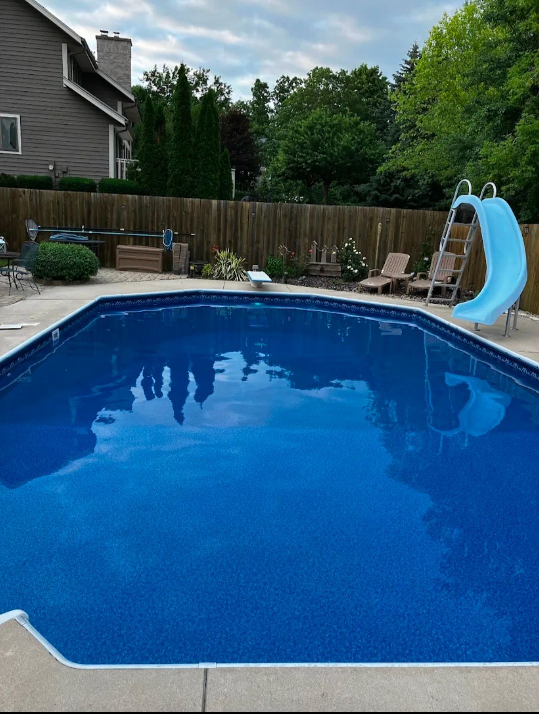 A large white house with a swimming pool in front of it