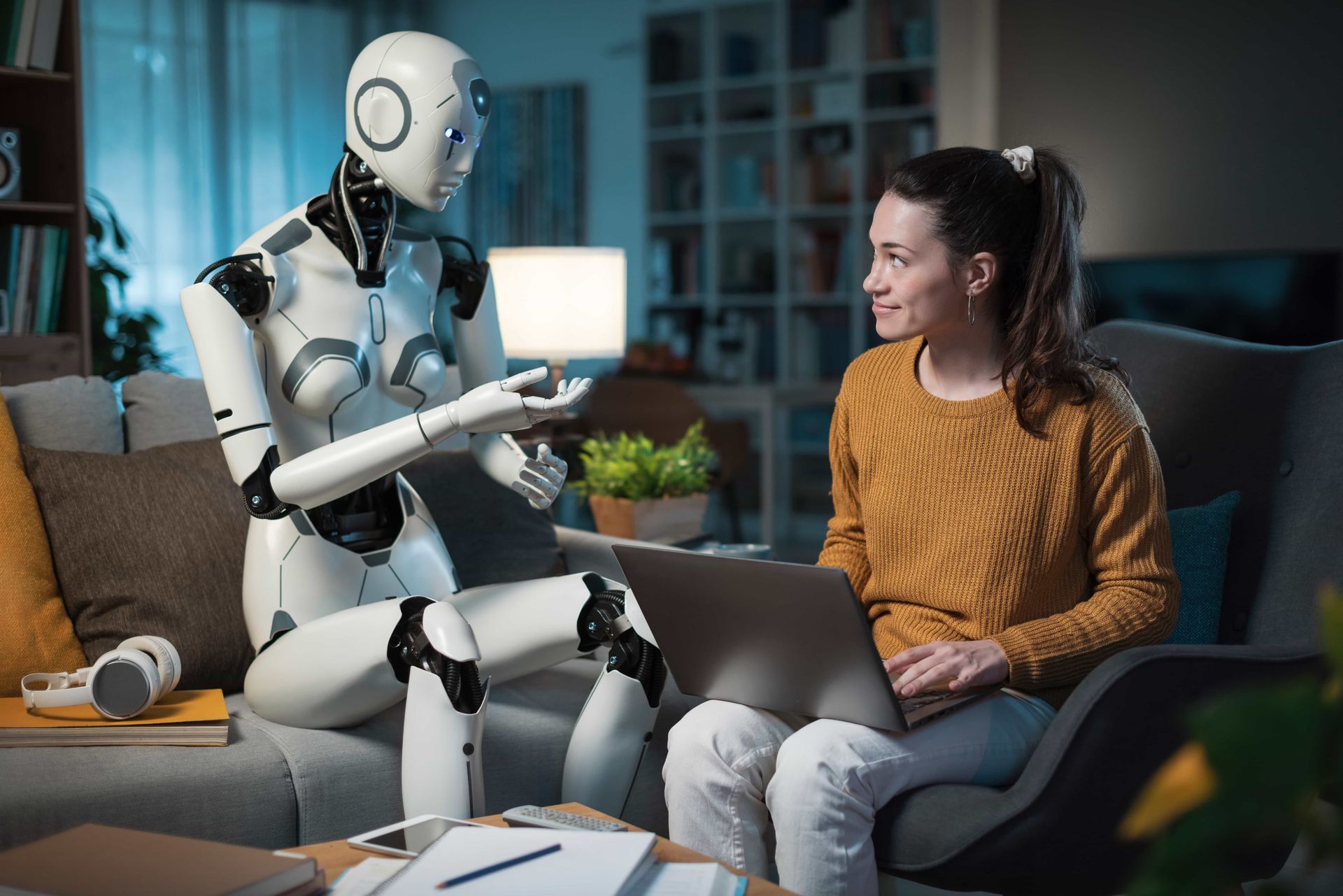AI Robot and person talking on a couch, person using Ai search, robot gesturing, indoor setting.