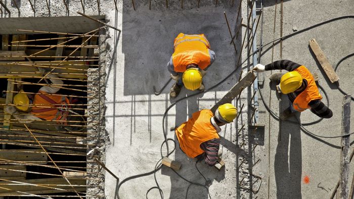 Construction workers building a house