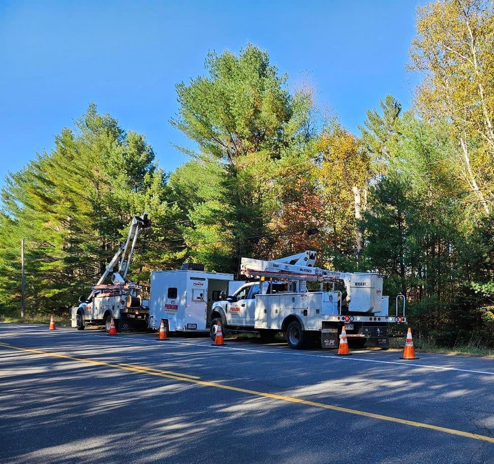 A row of utility trucks parked on the side of a road