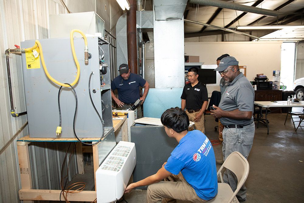 Group of Men are Working on an Air Conditioner - Evansville, IN - TRM Heating and Cooling