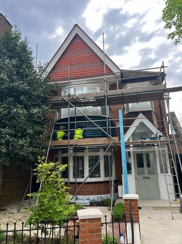 Exterior renovation by D&R Roofing in Wimbledon, showing roof and window work.