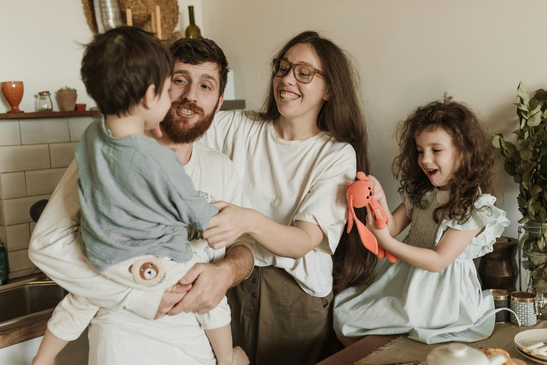 A family is posing for a picture in a living room.