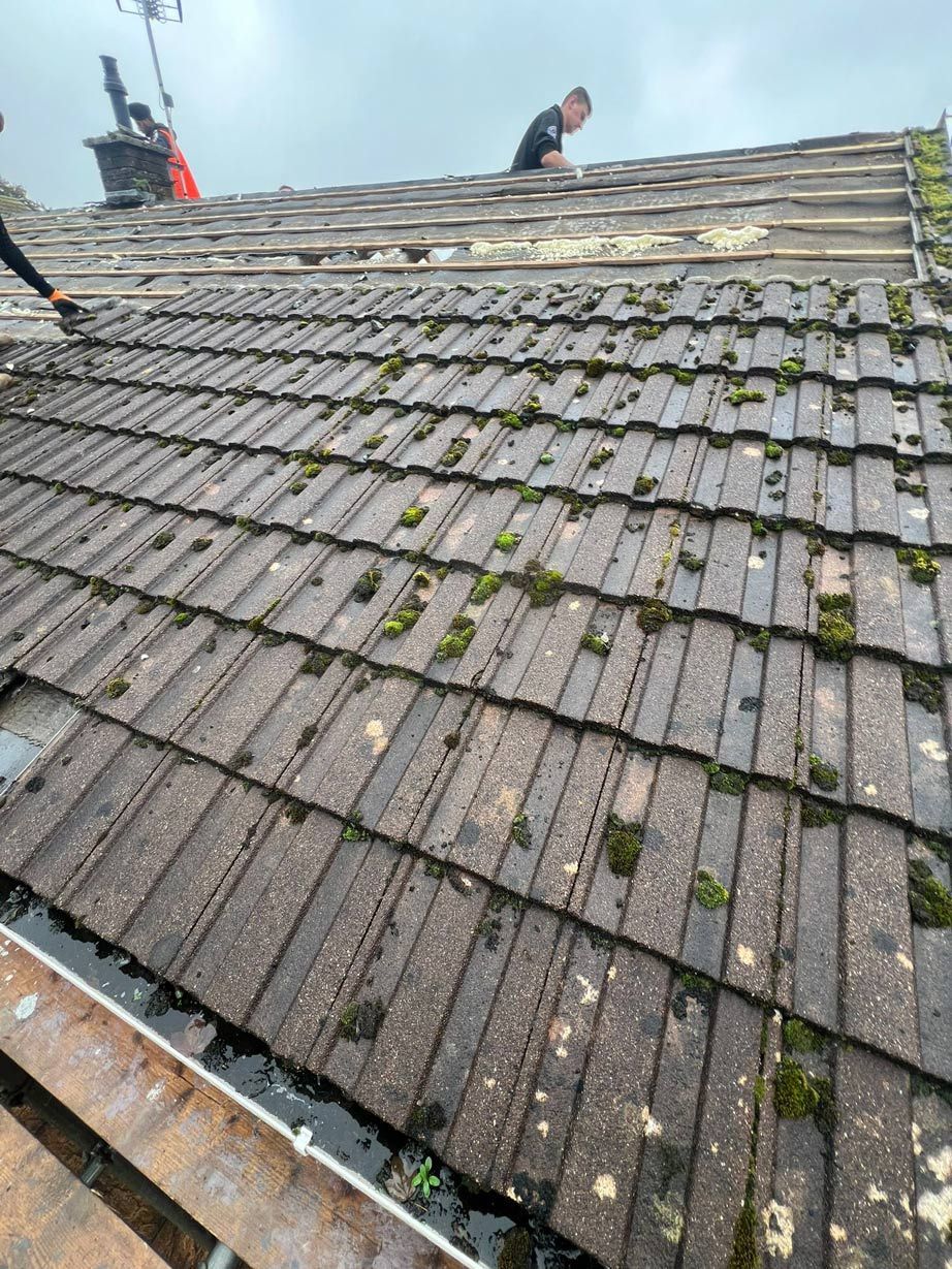 A man is working on the roof of a building.