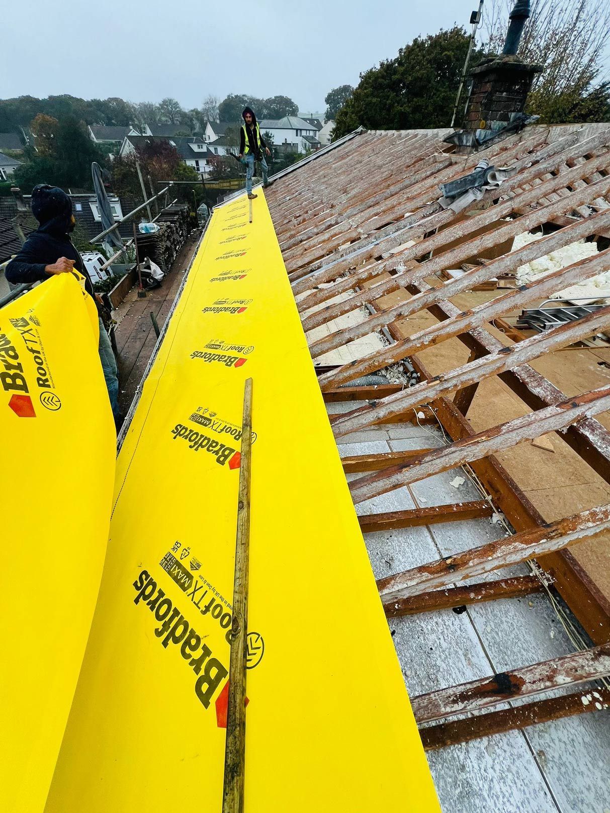 Roofer in Wimbledon installing new Bradfords roof membrane.