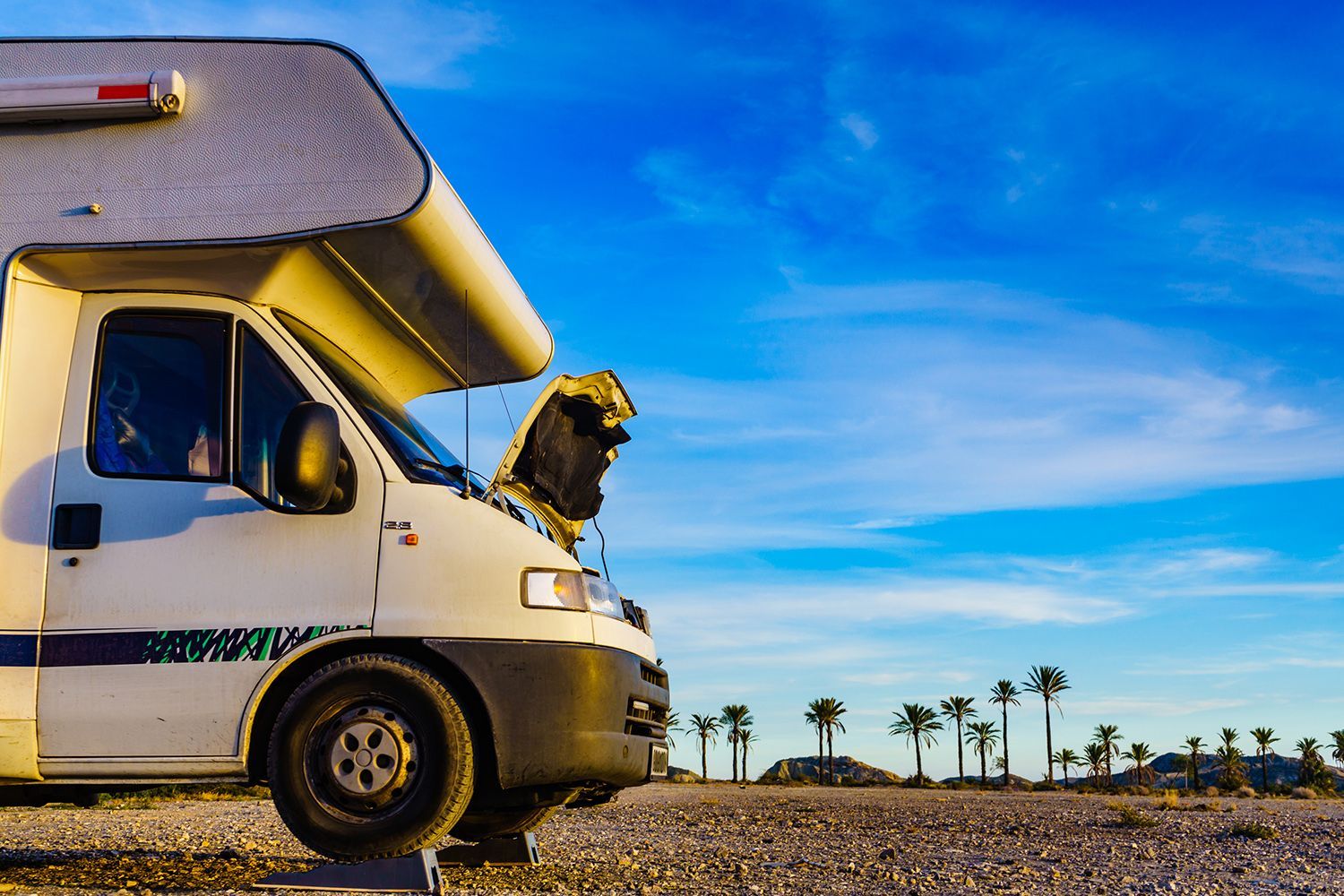 Motor home repair for engine breakdown issues in a recreational vehicle parked on leveling blocks.