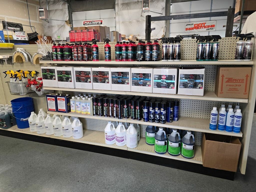 Shelves stocked with automotive detailing products in a store.