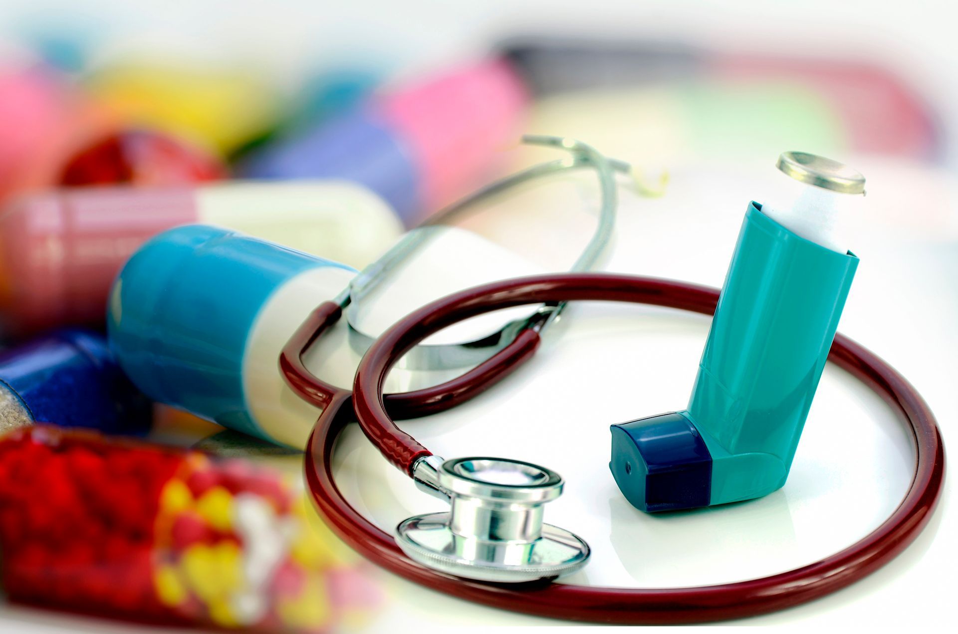 A stethoscope and an inhaler are on a table