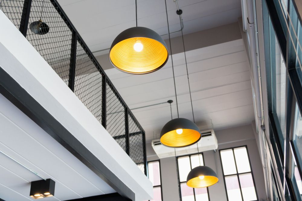 Three Pendant Lights Are Hanging From the Ceiling of a Building — State Connect In Bangalow, NSW