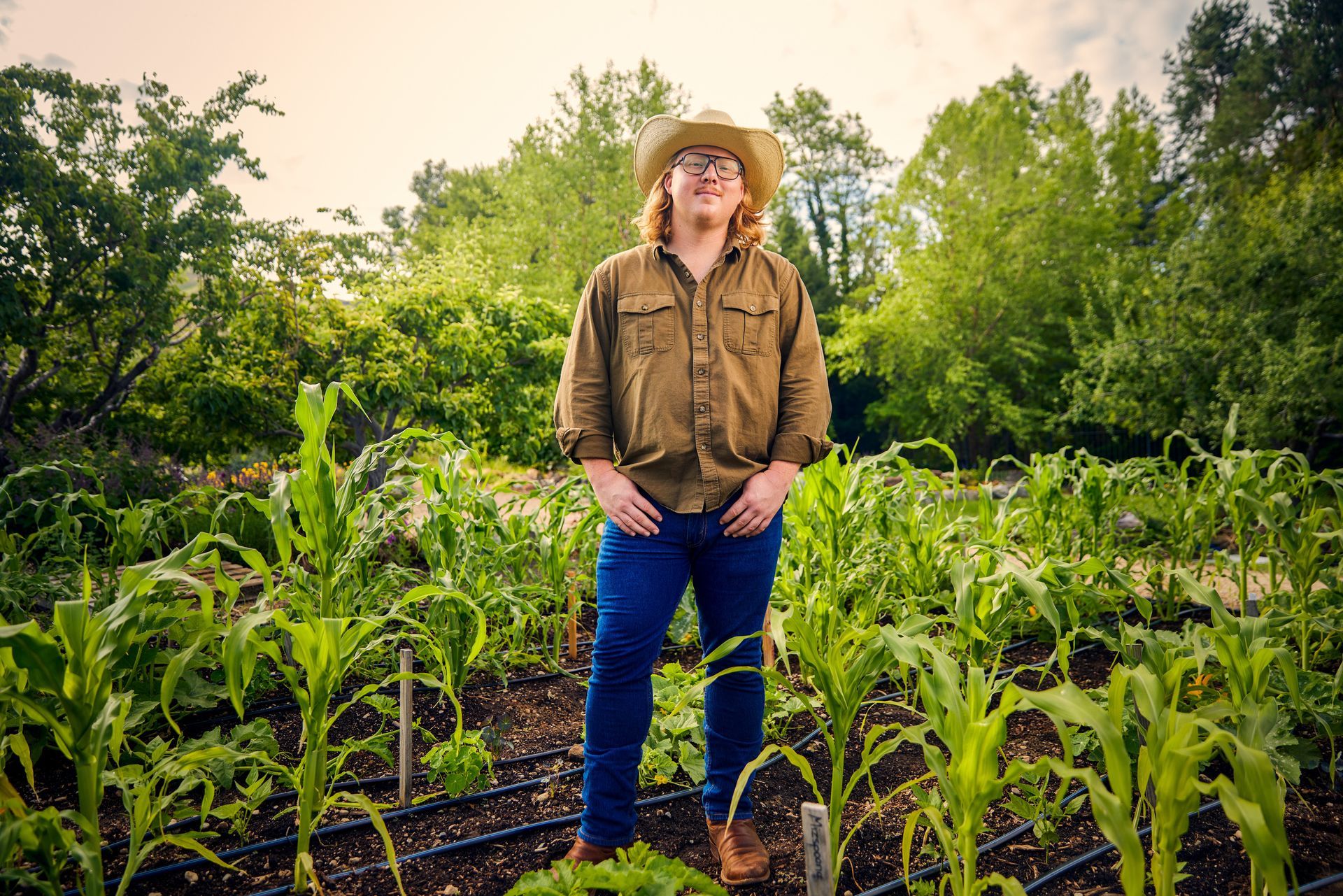 A man in a cowboy hat is standing in a garden. designing websites in Boise Idaho