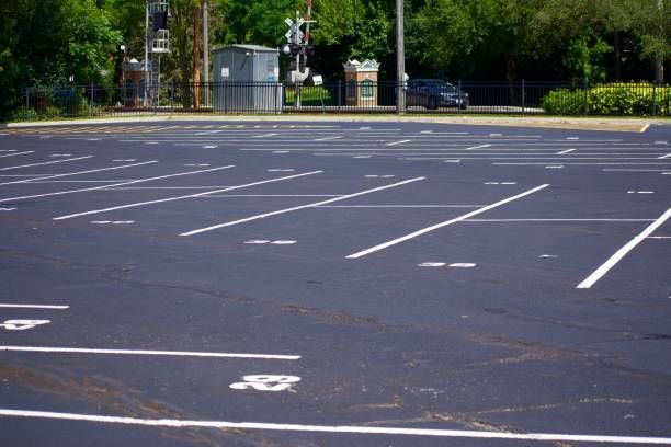 Empty parking lot with white painted parking space lines.