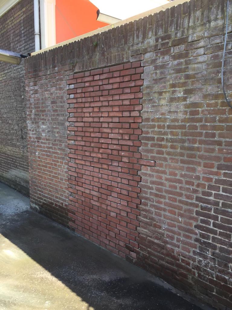 Deursparing in tuinmuur