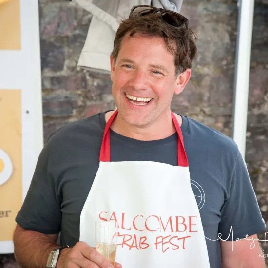 Man wearing an apron that says 