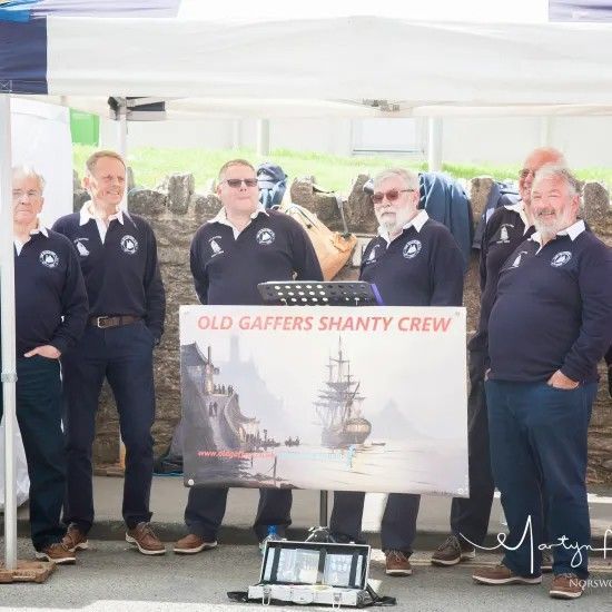 Seven men in navy shirts with 