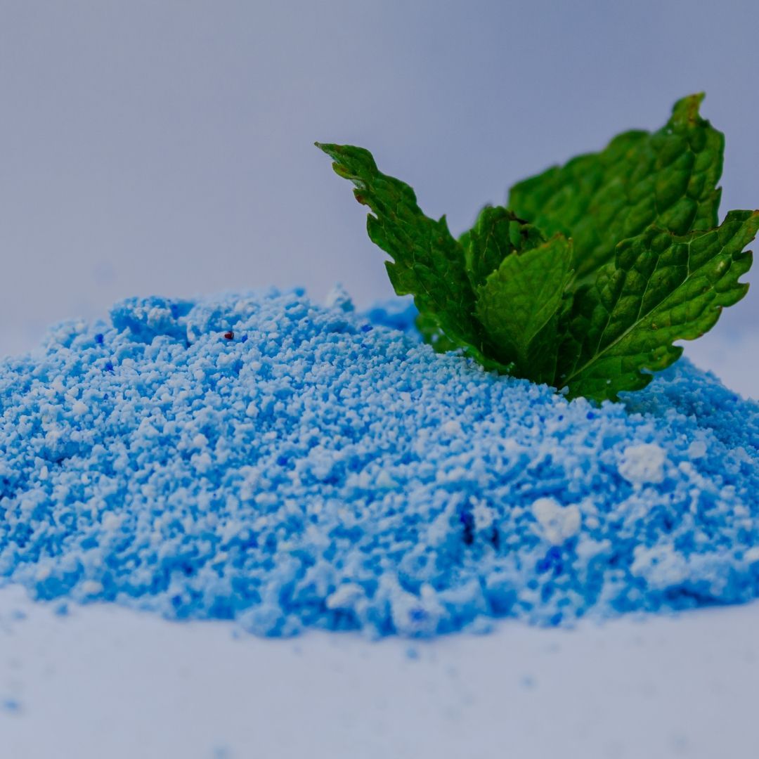 A pile of blue powder with a mint leaf on top