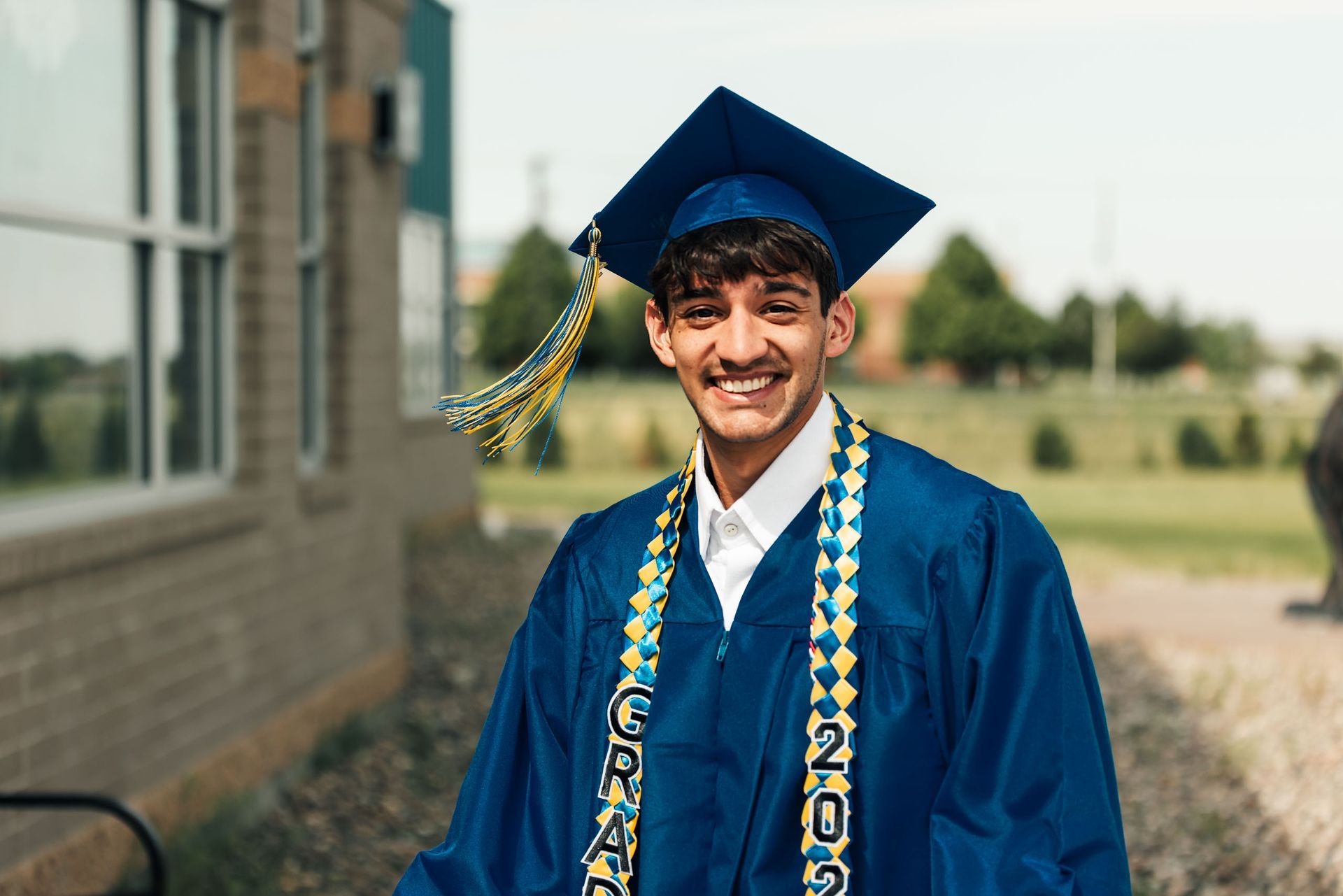 A man is using a soldering iron to write on a piece of wood.
